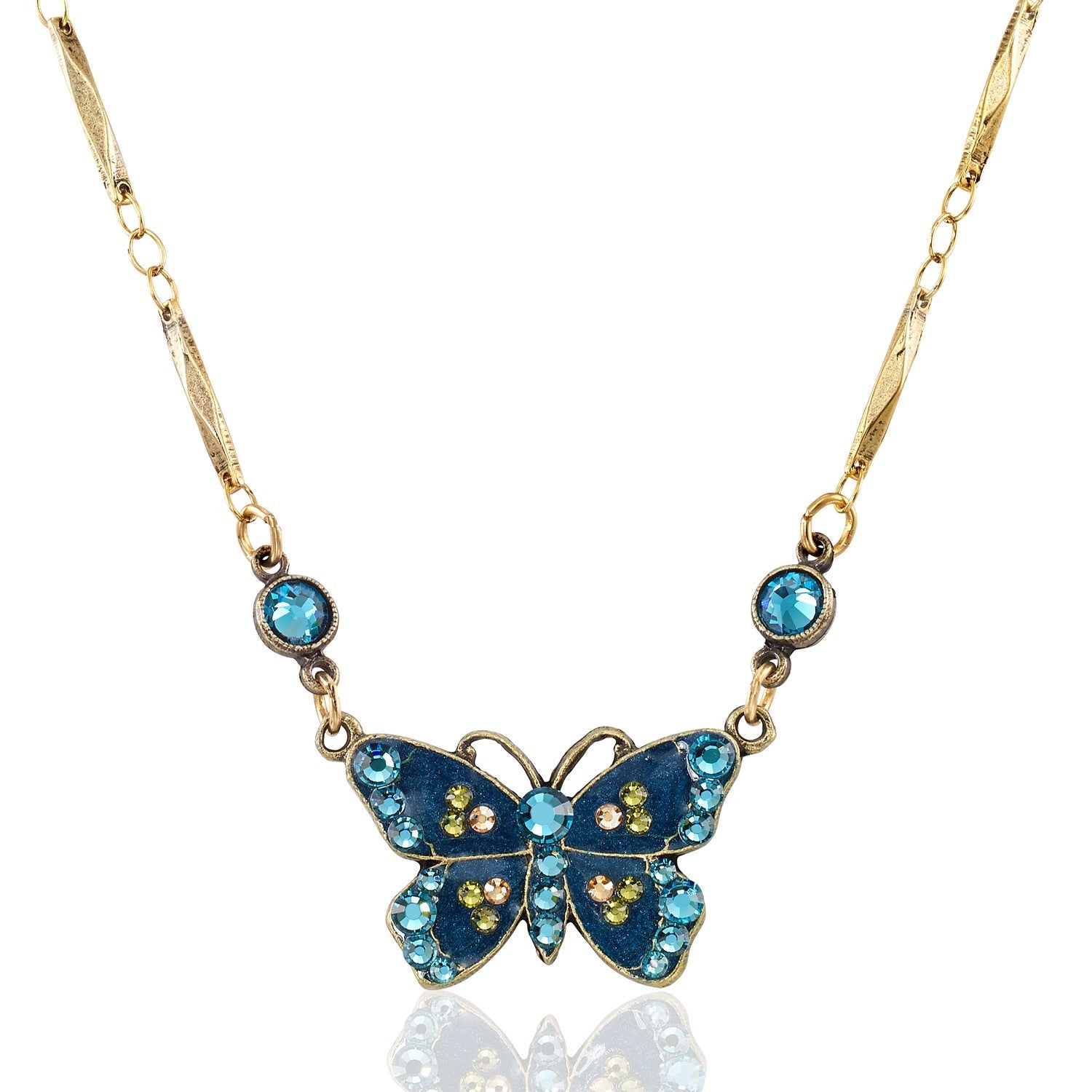 The Enamel & Stone Teal Butterfly Necklace by Anne Koplik Designs, Inc. features a butterfly pendant with blue and yellow stones and two round blue crystals on a decorative gold chain—a refined crystal-embellished accessory.