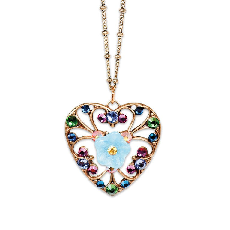 The Filigree & Stone Heart/Flower Necklace by Anne Koplik Designs, Inc. features a handmade gold heart filigree, multicolored gemstones, and a central blue flower pendant on a delicate gold chain.