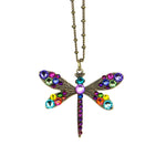 The Multi Stone Filigree Dragonfly Necklace by Anne Koplik Designs features colorful gemstones on its wings and body, accented with rainbow details and suspended from a beaded chain.