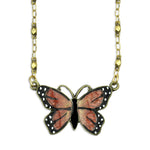 The Mini Monarch Butterfly Necklace by Anne Koplik Designs, Inc. features a gold chain and a hand-enameled pendant with orange and black wings accented by white spots—a beautiful piece of symbolic butterfly jewelry.