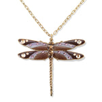 The Enamel & Stone Mocha/Lavender Dragonfly Necklace by Anne Koplik Designs, Inc. features a gold chain with a detailed dragonfly pendant in purple, brown, and gold enamel with gemstone accents on an adjustable brass chain. Lead free.