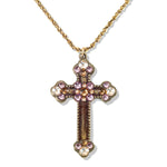 The Enamel & Stone Mocha/Lavender Cross Necklace by Anne Koplik Designs, Inc. features a gold, lead-free adjustable chain and a cross pendant adorned with pink and clear stones at each end and center.