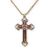 The Enamel & Stone Mocha/Lavender Cross Necklace by Anne Koplik Designs, Inc. features a gold, lead-free adjustable chain and a cross pendant adorned with pink and clear stones at each end and center.