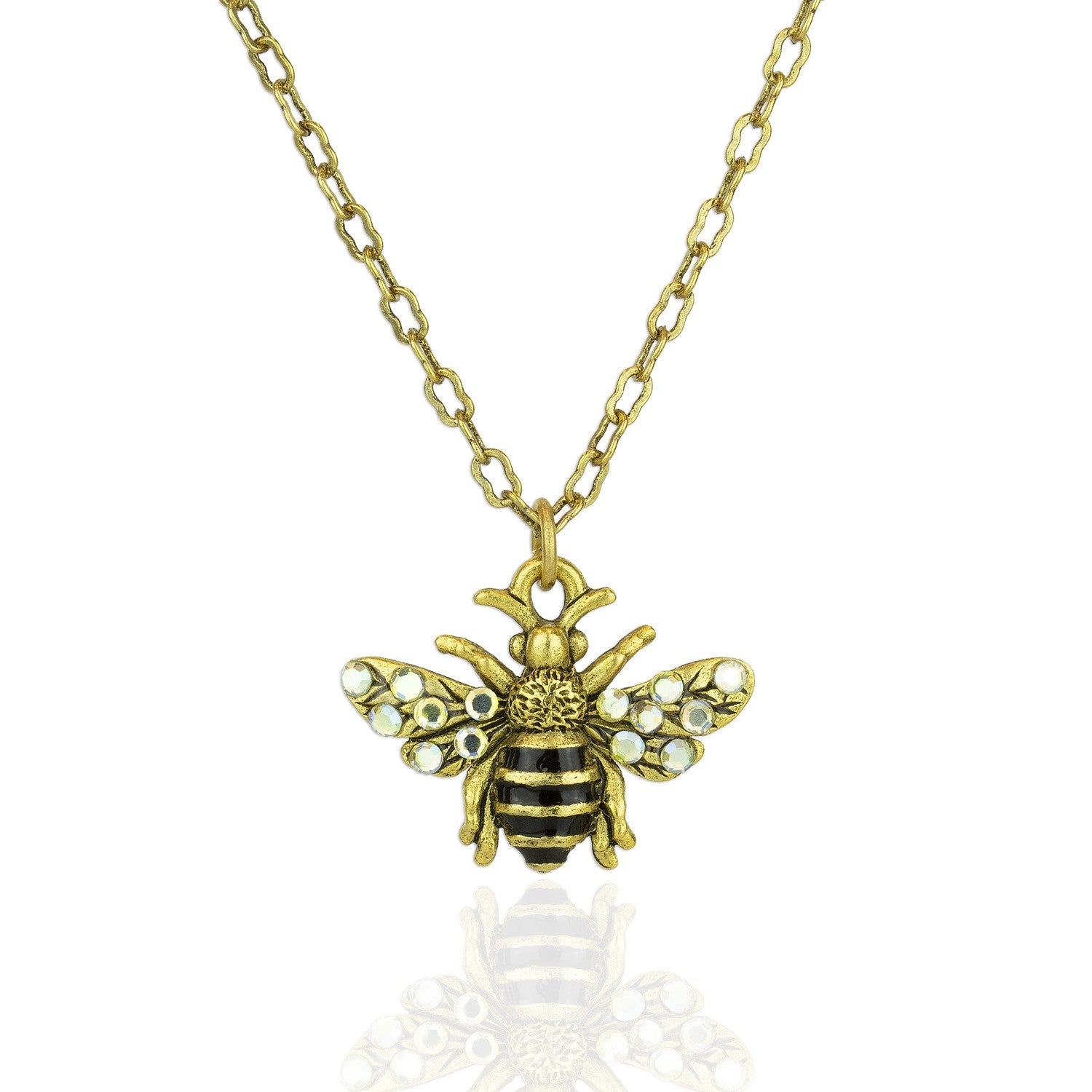 The Whimsy Flying Bee Necklace by Anne Koplik Designs, Inc. features a gold chain with a detailed bee pendant accented by black and gold stripes and crystal-adorned wings—an elegant addition to any jewelry collection.