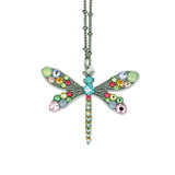 The Multi Stone Medium Dragonfly Necklace by Anne Koplik Designs, Inc. features a silver-plated chain with colorful gemstones in blue, pink, green, and yellow for a vibrant statement.