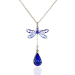 Anne Koplik Designs' Enamel/Crystal Blue Dragonfly w/ Sapphire Drop Necklace showcases silver-plated jewelry with blue and white enamel wings and a sparkling sapphire teardrop pendant.