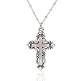 The Enamel & Stone Fancy Cross Pink Necklace by Anne Koplik Designs, Inc. features a pink-adorned cross pendant on an adjustable chain. This lead- and nickel-free piece is pictured on a white background, exuding timeless elegance and comfort.