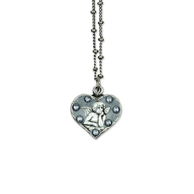 The Whimsey Angel Necklace by Anne Koplik Designs, Inc. features a heart-shaped angel pendant with a raised cherub and sparkling stones—a beautiful protective silver necklace for any occasion.